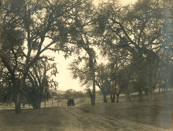 Automobile on country road, circa 1920 (1990-72-35-250)
